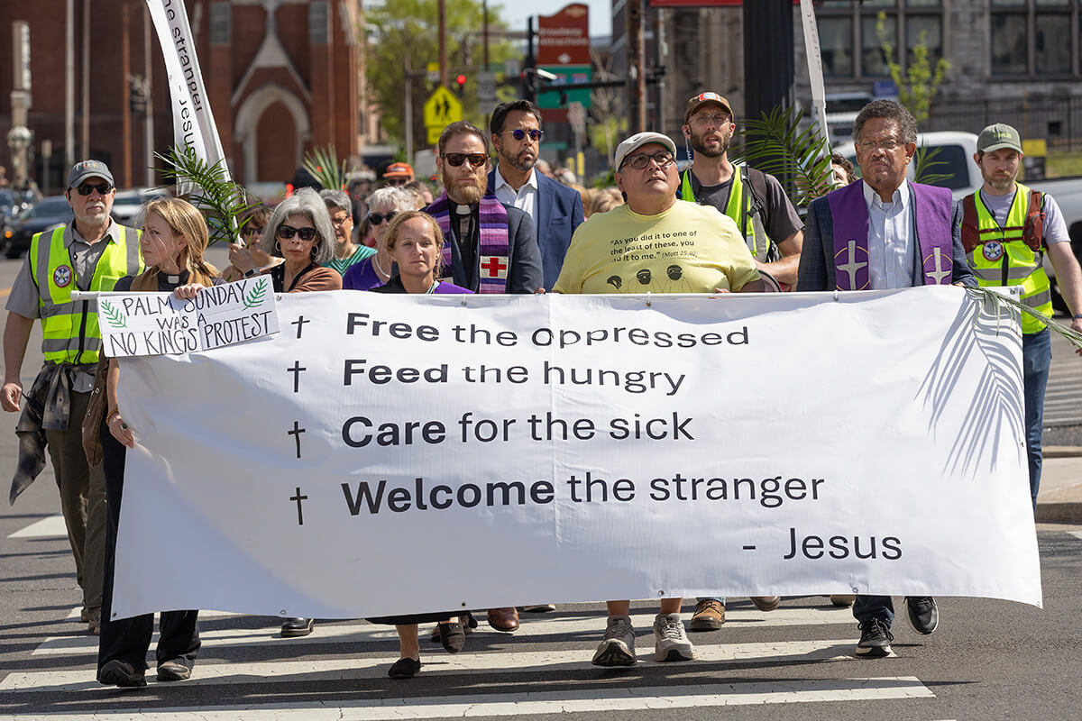 Faith leaders carry a banner lifting up Jesus’ call for social justice in Matthew 25 during a Palm Sunday Witness in Nashville, Tenn.