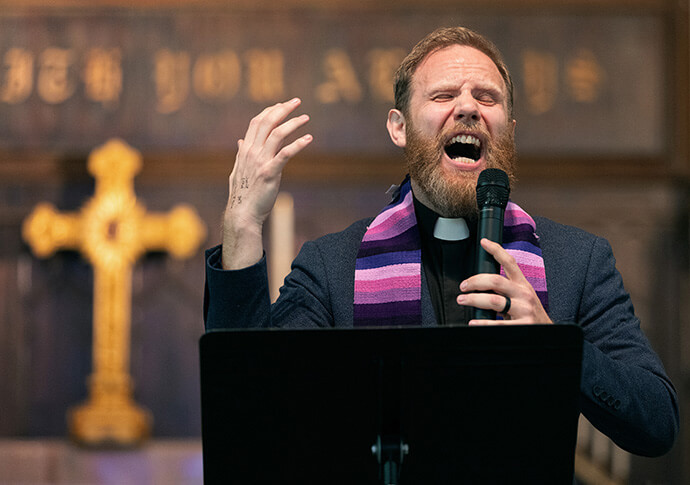 The Rev. Eric Mayle leads a litany of lament during a Palm Sunday Witness at First Evangelical Lutheran Church in Nashville, Tenn. in Nashville, Tenn., Mayle, pastor of Edgehill United Methodist Church in Nashville, said “Today we wave our palm branches; we march and cry out in solidarity with our neighbors, “Hosanna. God save us.” 