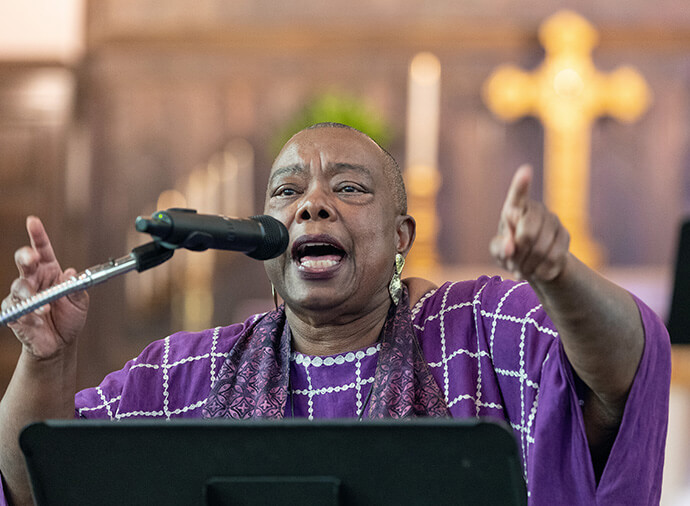The Rev. Marilyn Thornton leads singing during a Palm Sunday Witness at First Evangelical Lutheran Church in Nashville, Tenn. Thornton is pastor of Blakemore United Methodist Church in Nashville.