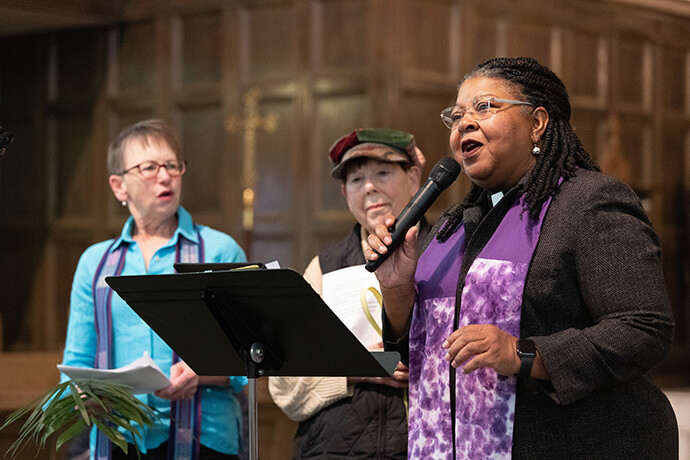 The Rev. Marie King (right) helps lead a litany during a Palm Sunday Witness at First Lutheran Evangelical Church in Nashville, Tenn. She is joined by the Rev. Heidi Hudnut-Beumler (left) and Betty Krogman. King is pastor of Seay-Hubbard United Methodist Church in Nashville. 