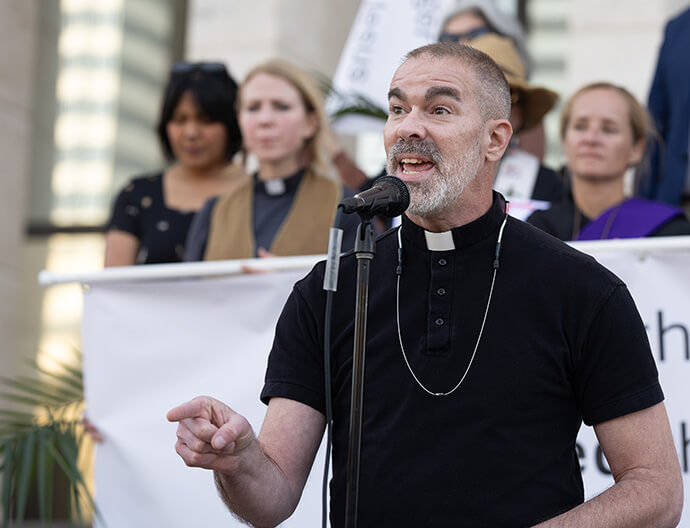 The Rev. Timothy Holton-Overcast leads a litany during a Palm Sunday Witness near the Tennessee State Capitol in Nashville. Holton-Overcast said the state’s General Assembly is making life and death decisions and he criticized Gov. Bill Lee’s decision to forgo federal funding for a summer food program for low-income children.