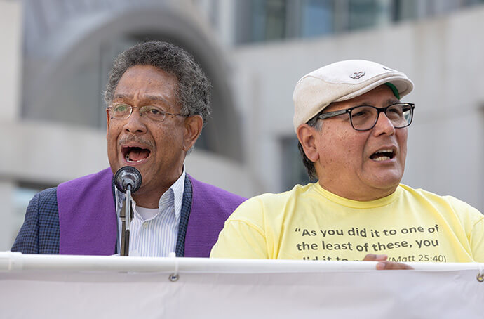 The Rev. Stephen Handy (left) leads a litany outside the Fred D. Thompson Federal Building in Nashville, Tenn. Handy is lead pastor of McKendree United Methodist Church in Nashville. At right is Patrick Camacho of Edgehill United Methodist Church in Nashville. 