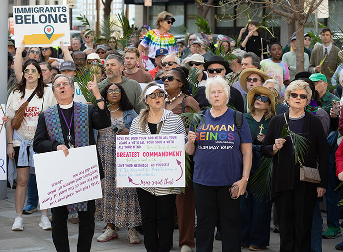 Participants in a Palm Sunday Witness gather outside the Fred D. Thompson Federal Building in Nashville, Tenn. 