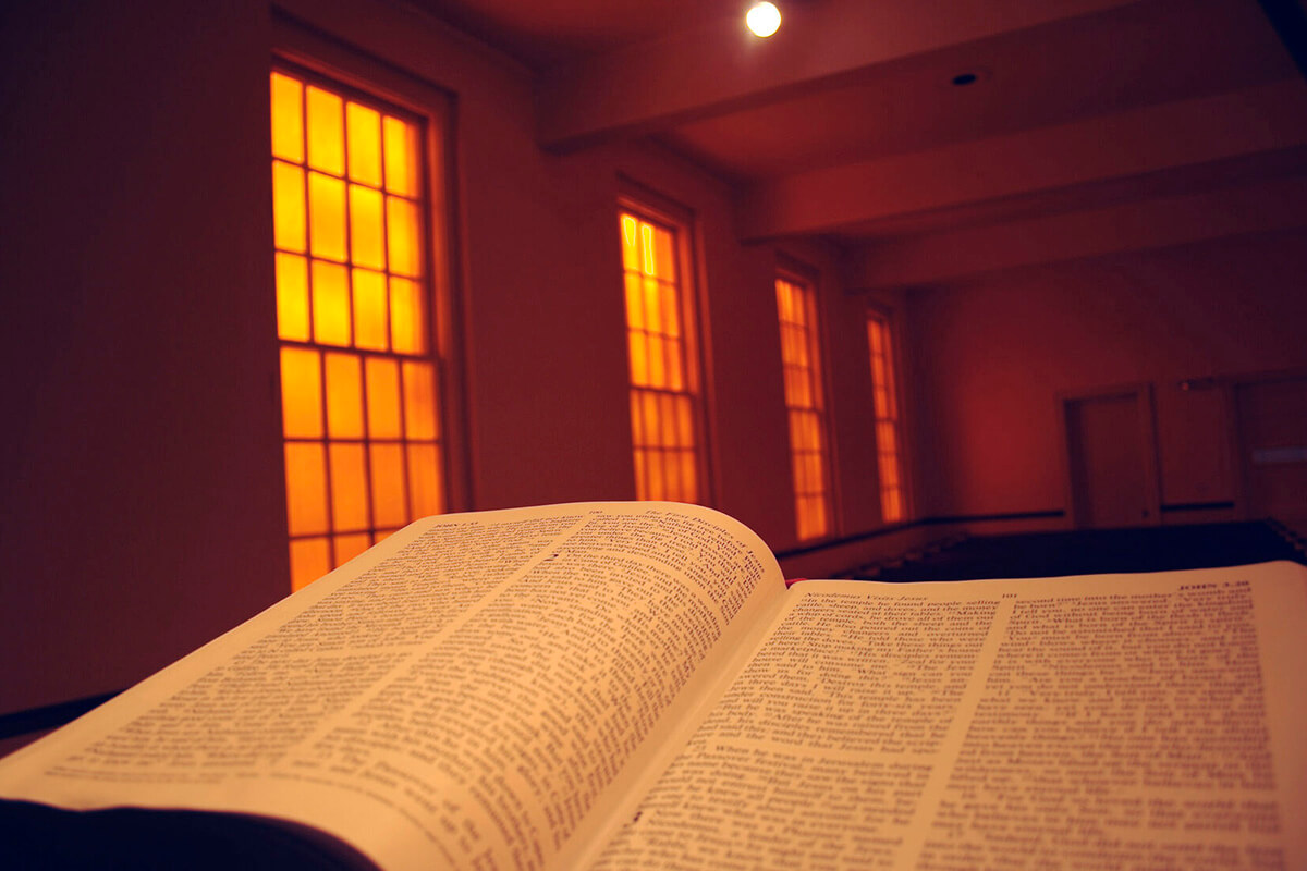 Amber stained-glass windows illuminate the Bible that sits on the altar of Glendale United Methodist Church in Nashville, Tenn. Starting with Good Friday and into the Easter season, United Methodists and other Christians have new recommended Bible readings for worship. Photo by Steven Adair, United Methodist Communications.