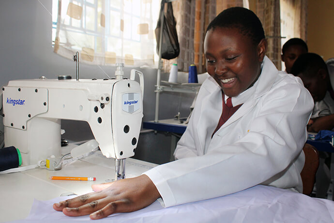 Fourteen-year-old Kupakwashe Chishanga does straight stitching with one of the advanced sewing machines at the new uniform factory at Murewa High School. Photo by Kudzai Chingwe, UM News.