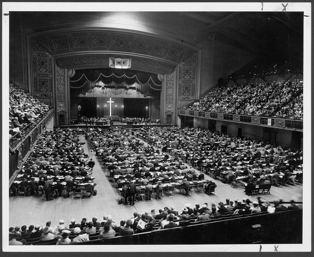 The Methodist Church’s 1956 General Conference meets from April 25 to May 7 in the municipal auditorium in Minneapolis. On May 4, the first Friday of the legislative assembly, the delegates voted to make women eligible for full clergy rights. “Now it is up to us to prove in clear and deep witness to the whole church our consecration and our loyal devotion to the work of the Kingdom of God,” said Margaret Henrichsen, a General Conference visitor, after the vote. In 1967, she became the first U.S. woman appointed district superintendent. Photo courtesy of Archives and History. 