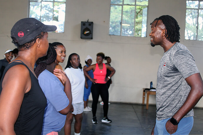 Milcah Mudekunya (left in black cap) receives instruction from Zumba instructor Elvis Mushawenyoka (right) at Chisipiti United Methodist Church. The popular exercise has caught on at the church as a way to destress and stay in shape. Photo by Kudzai Chingwe, UM News.