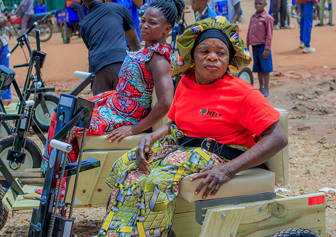 Two women sit on their new adapted bicycles during a handover ceremony in Kamina, Congo. The selection of beneficiaries followed an inclusive and ecumenical process, involving members of the region’s Methodist, Catholic and Pentecostal communities. Photo by Yamba Kisonga Barthélémy, UM News.