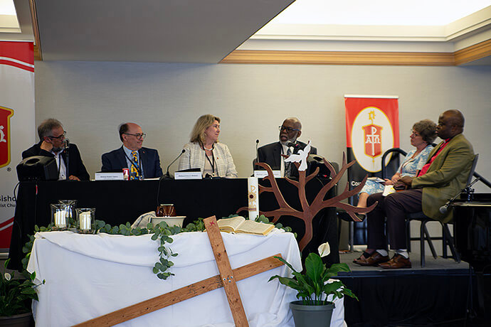 Bishops and leaders of the Connectional Table listen as retired Bishop Warner H. Brown Jr., at right, speaks during an April 29 panel on the U.S. jurisdictions. Pictured from left are Bishops Harald Rückert, David Bard, Kristin Stoneking and Brown. To the side are Judi Kenaston, the chief connectional ministries officer of the Connectional Table, and North Katanga Area Bishop Mande Muyombo, the Connectional Table chair and Council of Bishops president-designate. Photo by Paul Gómez, United Methodist Communications.