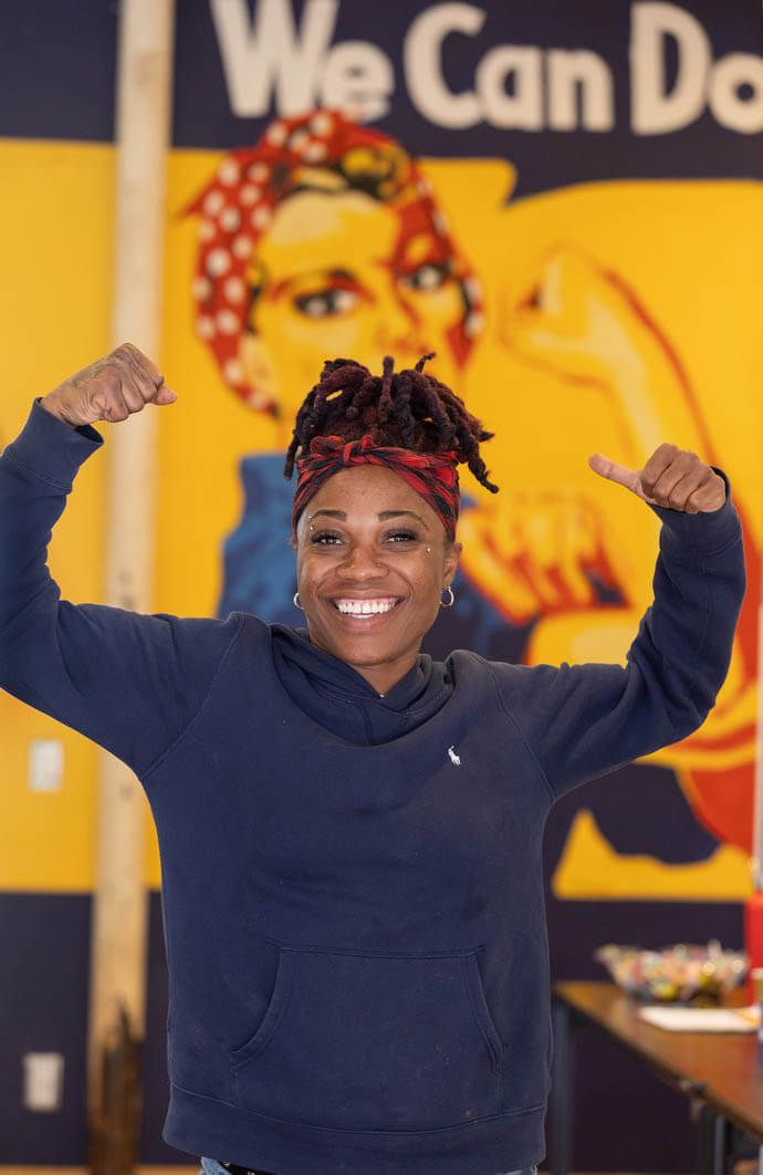 Kenisha Thomas mimics the pose in a motivational poster at the Women in Construction program in Biloxi, Miss. 