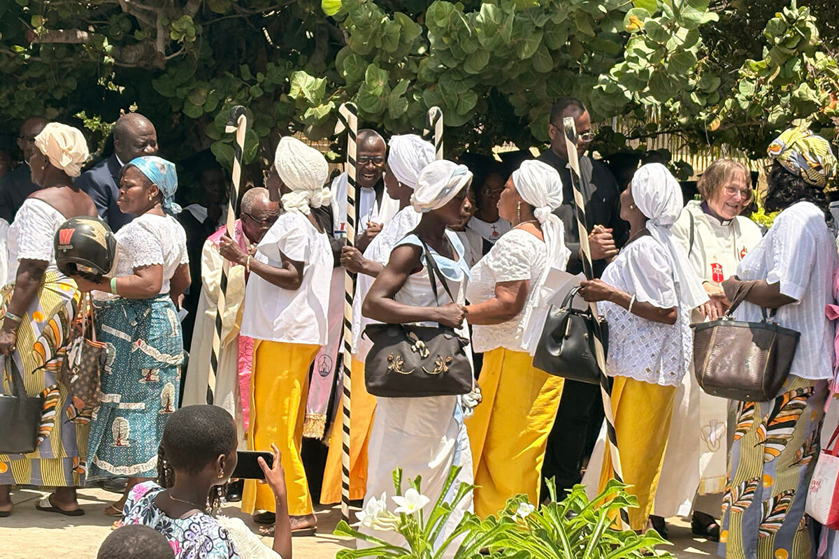 Church members from Ebenezer Temple of the Methodist Church of Togo greet Africa Methodist Council visitors after Sunday worship service on May 17 in Aného, Togo. Ebenezer, built in 1895, is the church’s oldest sanctuary. The council gathered leaders of Methodist denominations in Africa to discuss challenges on the continent and strengthen cooperation to help position the church as a prophetic voice for justice and peace. Photo by Eveline Chikwanah, UM News.