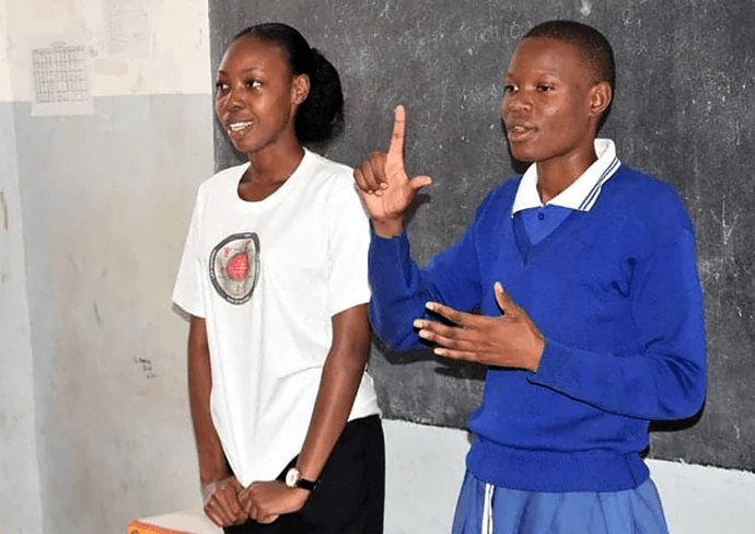Neema Ndalawa (left) presents a lesson on human rights and health at Buhongwa Secondary School in Mwanza, Tanzania, as student Elizabeth Zacharia translates in sign language. The United Methodist Church’s Yatosha Deaf Ministry provides training, mentorship and support for Deaf students at the school and across the Tanzania Conference. Photo by Robert Aloyce, UM News.