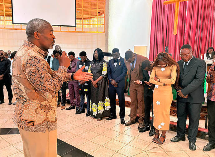 The Rev. Peter Mageto, Africa University vice chancellor, prays for the newest members of the institution’s alumni association. The former students, who graduated on June 6, attended worship service June 7 in the university’s Kwang Lim Chapel. Photo by Eveline Chikwanah, UM News.