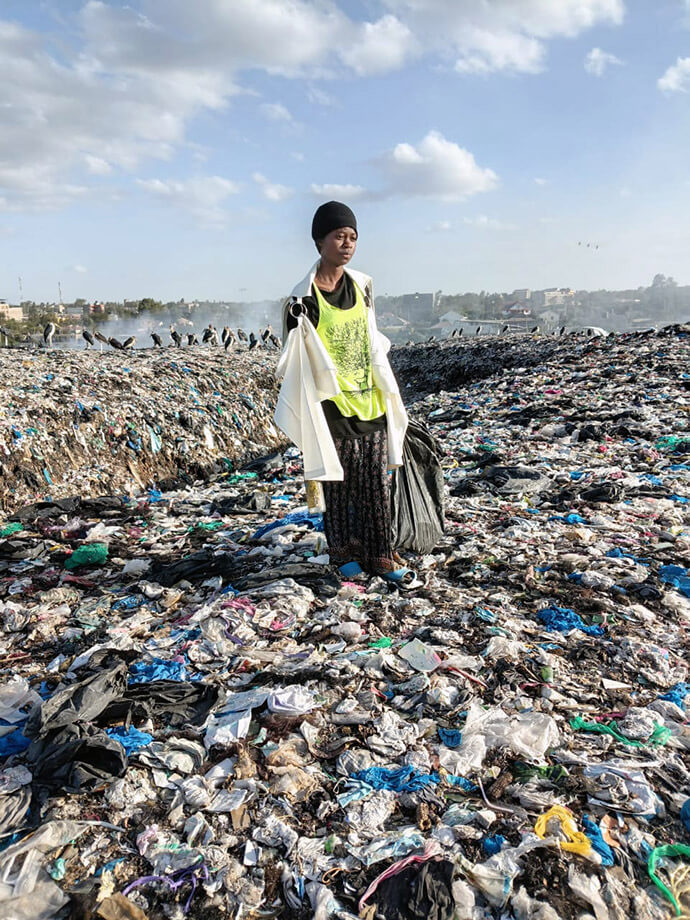 Gloria Kache stands on a dumpsite in Nairobi, Kenya, where she and her family had scavenged for plastics to sell. Outreach from nearby Parkview Kitengela United Methodist Church has provided new opportunities for the family and Gloria, who completed her secondary education with support from the No Girl No Cry ministry. She now has her sights set on college. Photo by Jackline Mwende. 