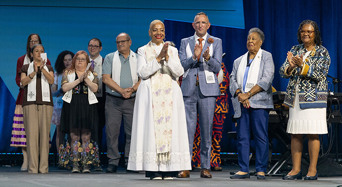 Clara Ester (second from right) joins in applauding newly consecrated deaconesses and home missioners of The United Methodist Church during the United Women in Faith Assembly 2026 in Indianapolis in May. Ester was a former vice president of the women’s organization. File photo by Mike DuBose, United Women in Faith.