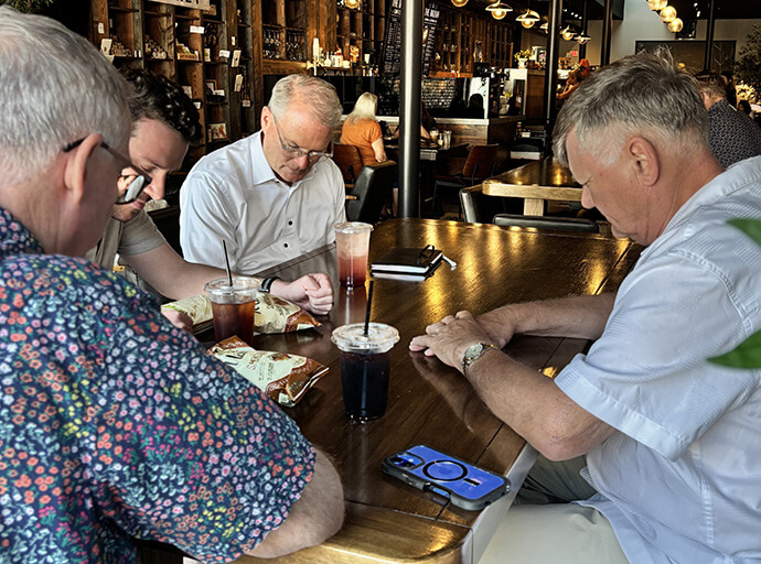 The Rev. Adam Hamilton (back left) prays with Pastor Daniel Reffner (to Hamilton’s right) and other colleagues June 1 at The Balkan in Pittsburg, Kan. Hamilton, pastor of Church of the Resurrection for the past 36 years, said he carries his faith with him on the campaign trail. Photo courtesy of the Hamilton campaign.