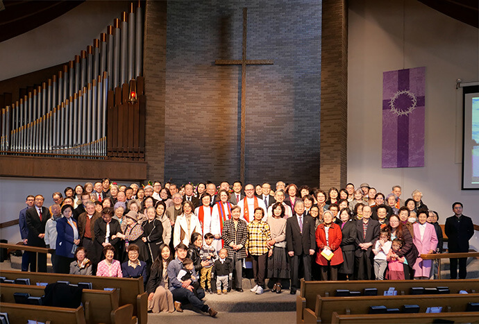 Friends, members of Sammool Korean United Methodist Church and Bishop Dan Schwerin of the Northern Illinois Conference gather following the congregation's chartering service in March 2024. Although the faith community began meeting to serve Korean immigrants in the greater Chicago area in 1996, the church was officially chartered by the conference two years ago. Photo courtesy of Sammool Korean United Methodist Church. 