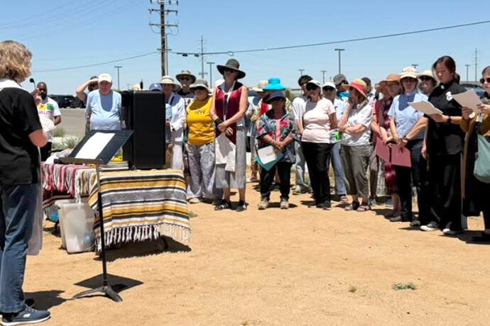 United Methodists in the California-Pacific Conference stand vigil June 16 outside of the Immigration and Customs Enforcement’s Adelanto Detention Center in Adelanto, California. In the heat of the Mojave Desert, those at the vigil read the names of the people who lost their lives as a result of U.S. immigration enforcement actions since January 2025. Photo courtesy of the California-Pacific Conference.