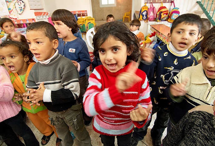 Palestinian children participate in an activity at school in the West Bank village of Wadi Foquin in 2006. United Methodists have been supporting community development projects in the village since 2009, including helping to maintain a kindergarten. File photo by Paul Jeffrey.