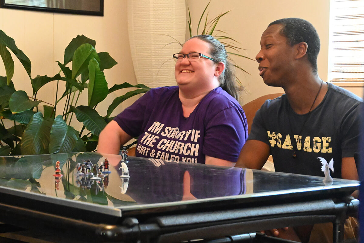 Laura Wenger and James Poland share a laugh at the start of a Dungeons & Dragons game on July 19 in the youth room of Glendale United Methodist Church in Nashville, Tenn. Several game players have joined the church after being attracted by the weekly role-playing games held Sunday after worship services. Photo by Jim Patterson, UM News. 