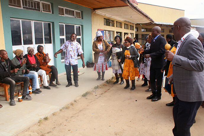 Members of Magamba Circuit join the Rev. Cosmas Chafanza (standing second from right) during an open-air evangelism campaign outside the Magamba shops in Rusape, Zimbabwe. Church leaders say community evangelism events are helping the circuit bring more people to Christ. Photo by Kudzai Chingwe, UM News.