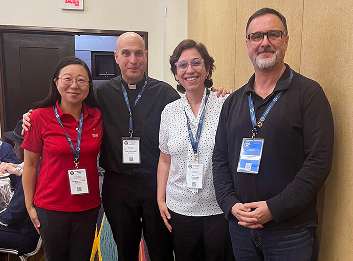 The Rev. Motoe Yamada Foor of United Methodist Discipleship Ministries (left) stands with Methodists she met at ecumenical young people’s gatherings nearly 30 years ago and reconnected with at the World Methodist Council meeting in 2026. From left, they are the Revs. Adriano Frattini of Uruguay, Fabiola Grandon-Mayer of the Northern Illinois Conference and Horacio Mesones, executive secretary of the Council of Evangelical Methodist Churches in Latin America. Photo courtesy of Yamada Foor. 