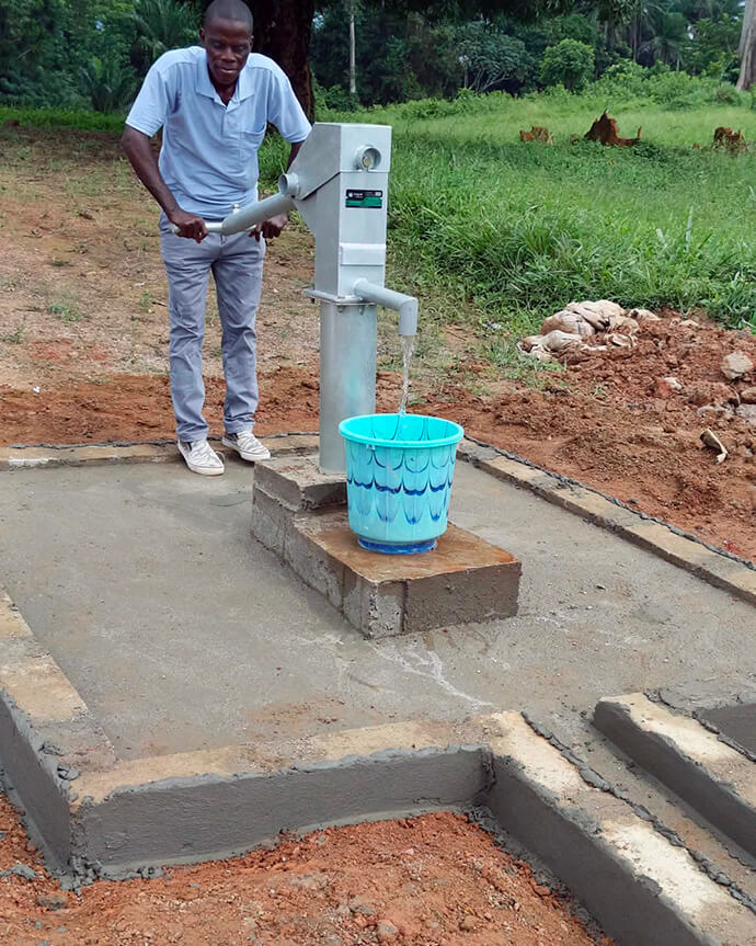 A man pumps water at a new well in the Kru Coast District of Grand Cess in Liberia. The well is a part of the Liberia Conference’s Water for Life initiative, a United Methodist Global Ministries Advance project. Photo courtesy of the General Board of Global Ministries.