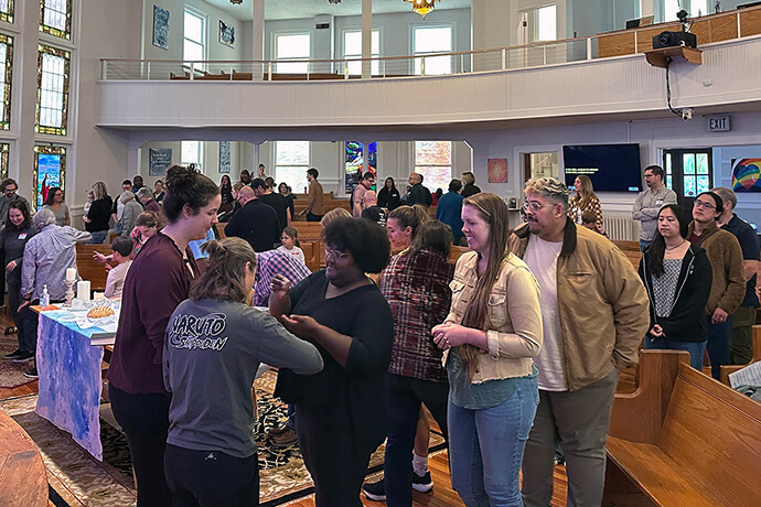 Congregants take communion on Aug. 9 at Atlanta’s Eastside Church. The church, which celebrates communion every Sunday, has drawn more young people. About a quarter of the people at Eastside’s Sunday worship attendance each week are under the age of 18. Photo by Karina Aragon-Buchanan, Eastside Church.