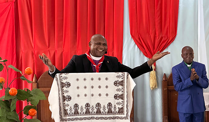 Bishop Nelson Kalombo Ngoy greets the community gathered at St. John’s Church in Kalemie, Congo, during the Tanganyika Annual Conference. At the bishop’s initiative, a mobile clinic was deployed on the sidelines of the conference, providing free healthcare and checkups to more than 600 congregants and pastors from underserved communities. Photo by Chadrack Tambwe Londe, UM News.