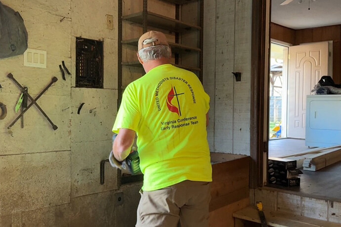 A member of a United Methodist Volunteers in Mission Disaster Response Team from Virginia works to clear a flood-damaged home in Western North Carolina during the days following Hurricane Helene in 2024. Photo by Lilla Marigza, UM News. 