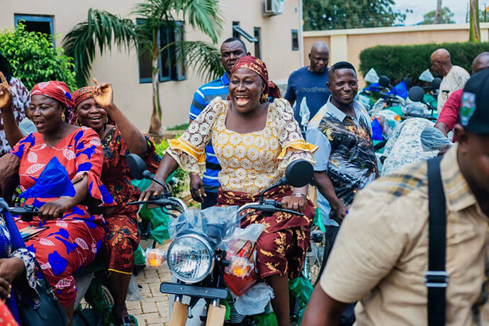 Dorcas Umar (center, in yellow), Nigeria Central Conference women's leader, Keziah Japheth (left front) with the Southwest Conference women's office, and Rose Adamu, women president of the Northern Nigeria Conference, test-ride new motorcycles at the handover ceremony. The church leaders said the bikes will greatly ease the burden of travel for their respective district superintendents in the field. Photo by Joseph Dauda Idris Balasa, UM News.