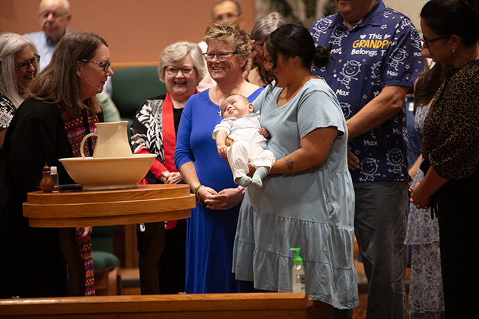 The Rev. Barbara Aziz, left, officiates at a baptism that coincided with the Oct. 4 centennial celebration of First United Methodist Church in Portland, Texas. “While compiling the historical records, we learned about this congregation's resilience, despite much being lost due to hurricanes,” Aziz said. “I can only credit the power of the Holy Spirit and the faith of all these people, past and present, for this resilience.” Photo by George Banda, Rio Texas Conference.