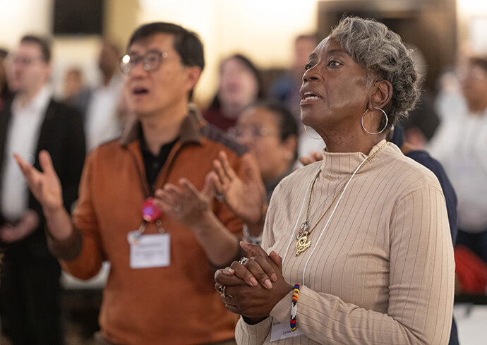  Bishop Delores J. Williamston (right) sings during morning worship at the United Methodist Leadership Gathering. Photo by Mike DuBose, UM News.